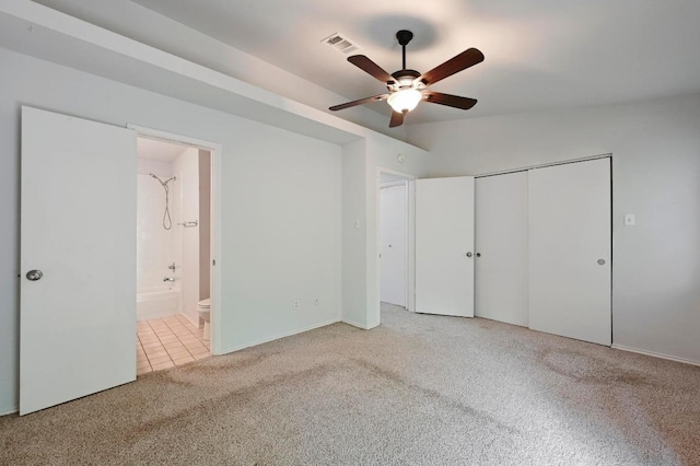 1815 River Crossing Cir Unit A, Austin, TX 78741 - unfurnished bedroom featuring light carpet, a closet, ensuite bathroom, and a ceiling fan
