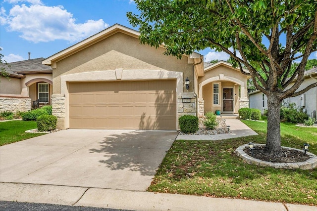view of front of home featuring stucco siding, an attached garage, and stone siding