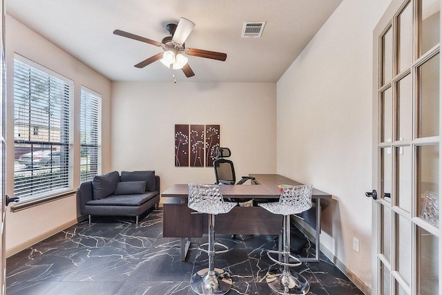 home office featuring visible vents, a ceiling fan, marble finish floor, and a healthy amount of sunlight