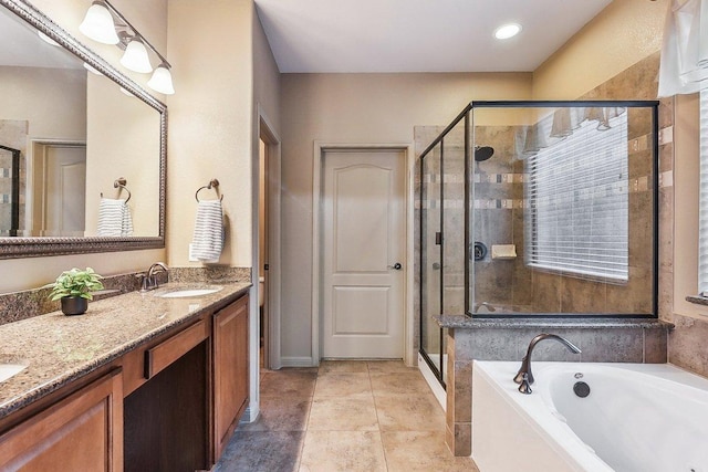 full bath with double vanity, a sink, a garden tub, and a stall shower