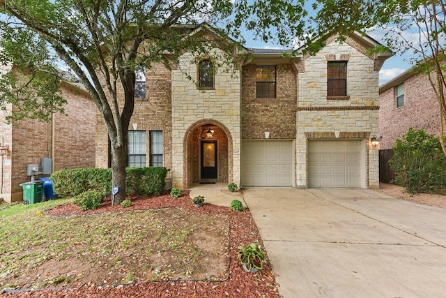 traditional-style home featuring an attached garage, driveway, and stone siding