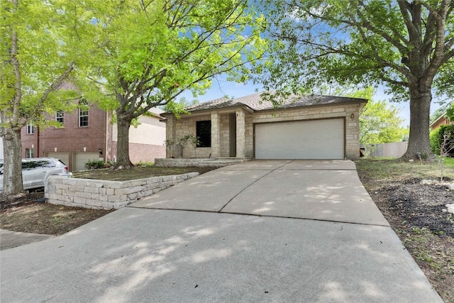 2720 Cascade Falls Dr, Austin, TX 78738 - view of front of house featuring stone siding, concrete driveway, and a garage
