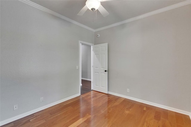 unfurnished room featuring crown molding, a ceiling fan, baseboards, and wood finished floors
