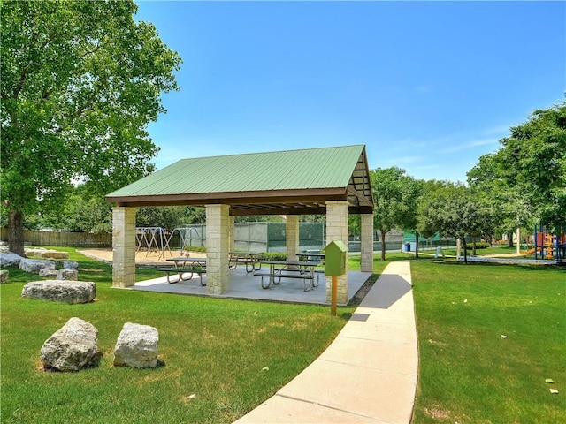 view of home's community with a gazebo, a yard, playground community, and fence