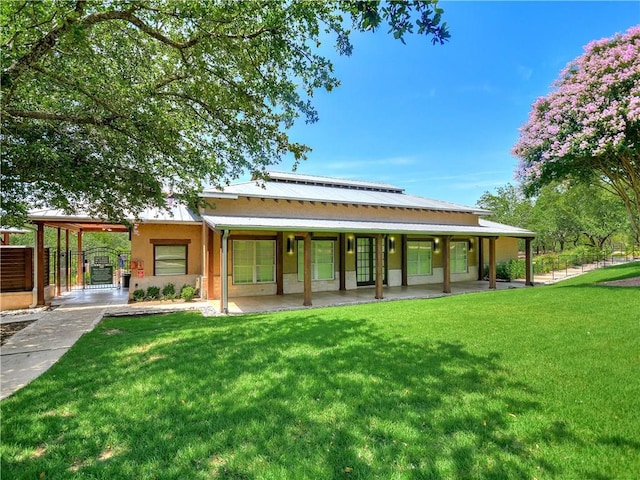 back of house with fence and a yard