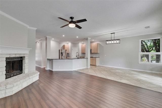 2720 Cascade Falls Dr, Austin, TX 78738 - unfurnished living room featuring ceiling fan, a fireplace, ornamental molding, light wood-style floors, and recessed lighting