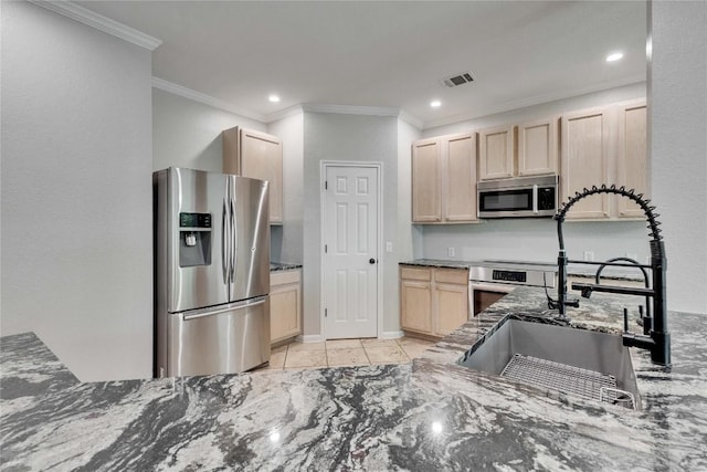 2720 Cascade Falls Dr, Austin, TX 78738 - kitchen with stainless steel appliances, light brown cabinets, ornamental molding, dark stone counters, and recessed lighting