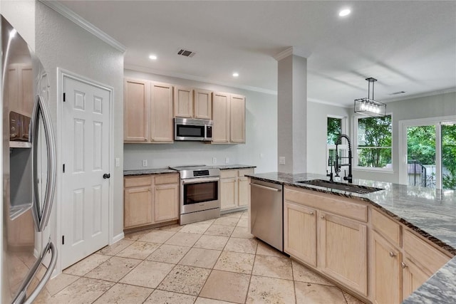 kitchen featuring light brown cabinetry, appliances with stainless steel finishes, a sink, visible vents, and ornamental molding