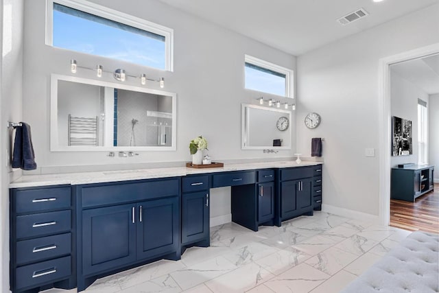 bathroom with double vanity, visible vents, a sink, baseboards, and marble finish floor