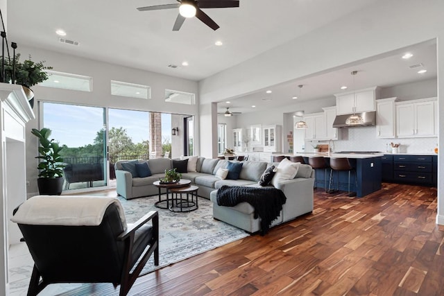 504 Loyal June Trl, Leander, TX 78641 - living room featuring a ceiling fan, dark wood-style flooring, recessed lighting, and a towering ceiling
