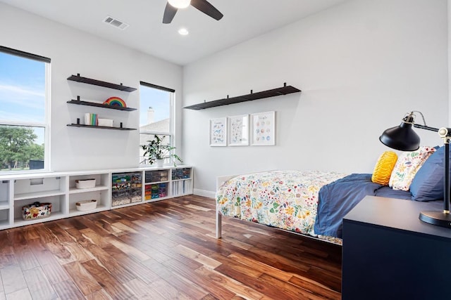 bedroom featuring a ceiling fan, visible vents, wood finished floors, baseboards, and recessed lighting