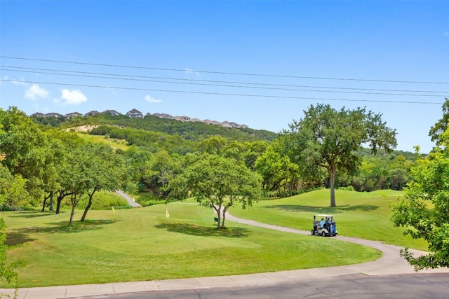 view of home's community featuring a yard and golf course view
