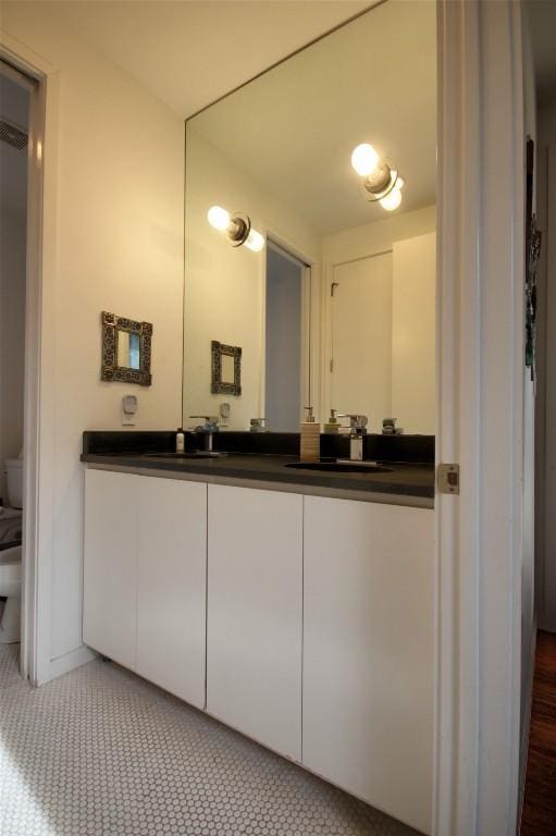 1145 Longhorn Dr, Burnet, TX 78611 - bathroom featuring toilet, double vanity, and tile patterned flooring