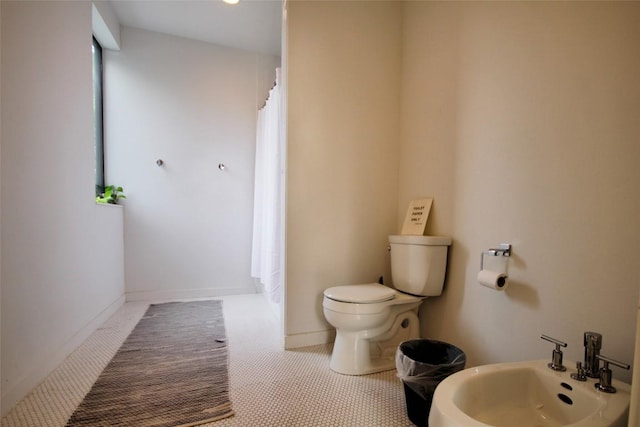 1145 Longhorn Dr, Burnet, TX 78611 - bathroom with toilet, a shower with curtain, and a bidet