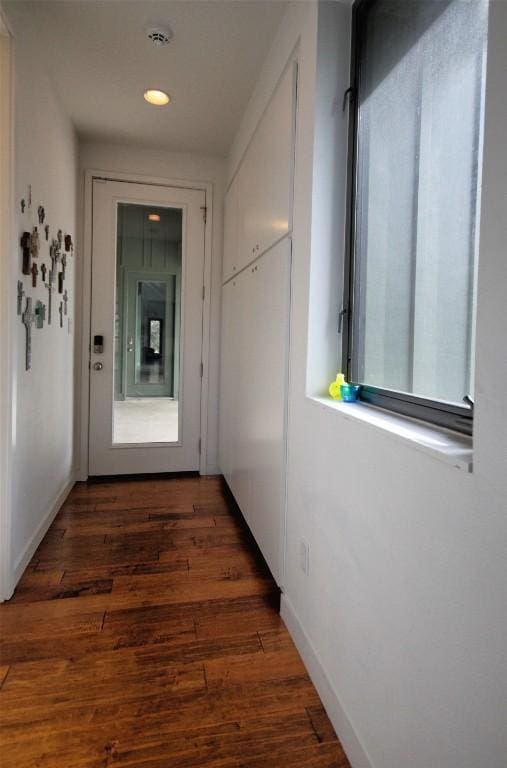 hall featuring recessed lighting, baseboards, and wood finished floors