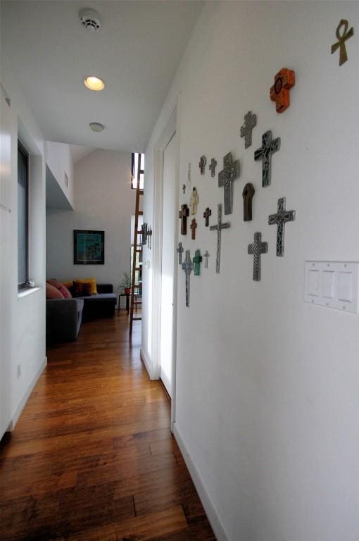 hallway featuring baseboards and wood finished floors