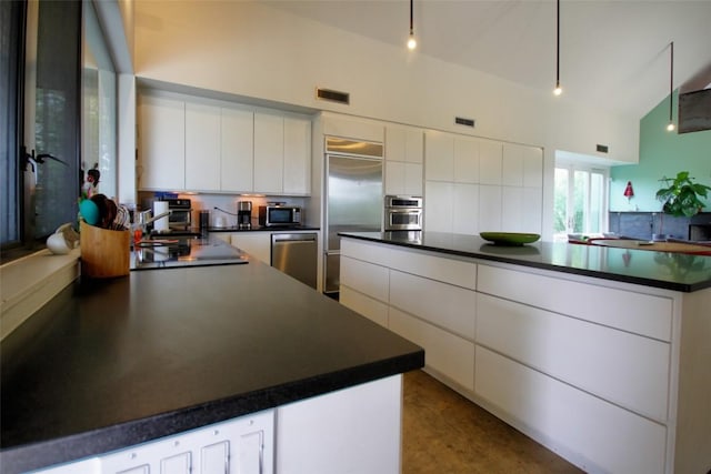 1145 Longhorn Dr, Burnet, TX 78611 - kitchen featuring stainless steel appliances, dark countertops, white cabinets, modern cabinets, and backsplash