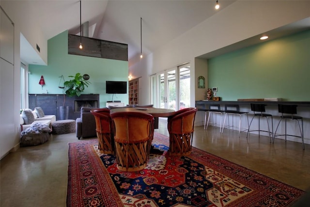 1145 Longhorn Dr, Burnet, TX 78611 - dining room featuring high vaulted ceiling and concrete flooring