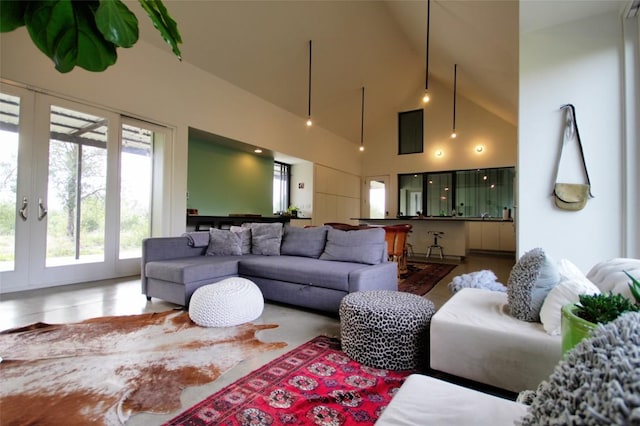 living room with high vaulted ceiling and french doors