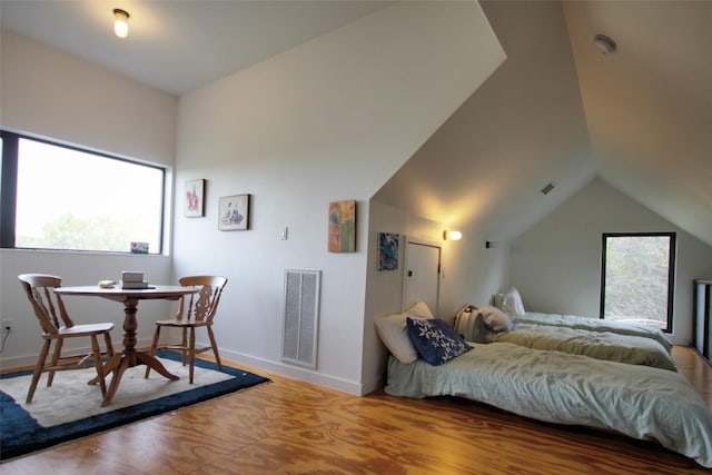 1145 Longhorn Dr, Burnet, TX 78611 - bedroom with wood finished floors, vaulted ceiling, and baseboards
