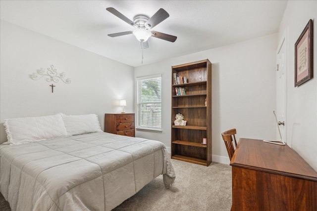 bedroom featuring baseboards, a ceiling fan, and light colored carpet