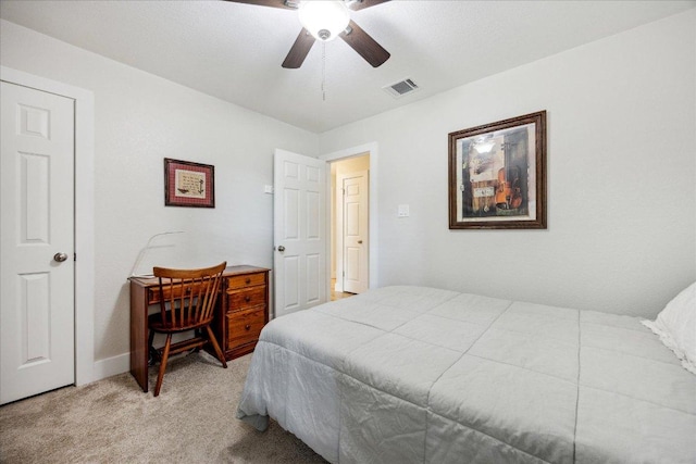 bedroom featuring a ceiling fan, baseboards, visible vents, and light carpet