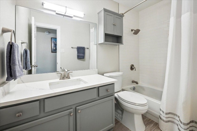 full bathroom with vanity, wood finished floors, shower / bath combo, and toilet