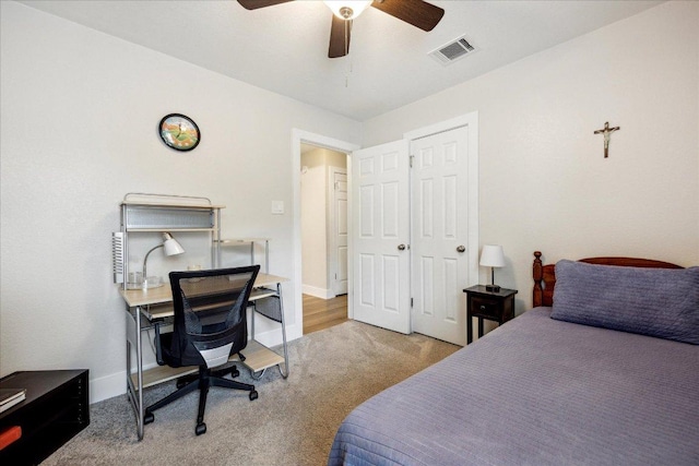 carpeted bedroom with ceiling fan and visible vents