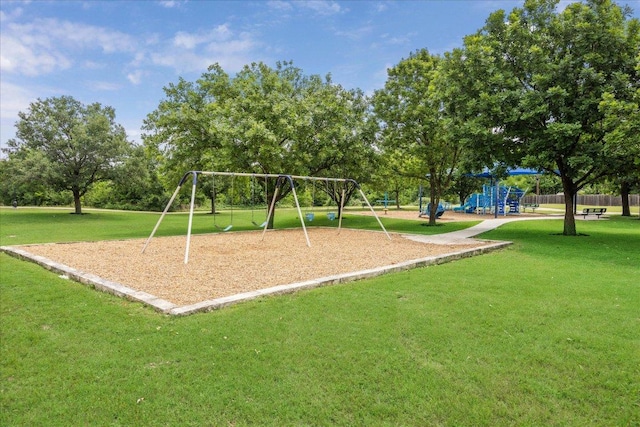 communal playground with fence and a yard