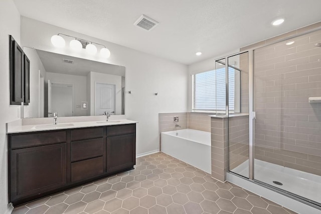 12126 Cantabria Rd, Austin, TX 78748 - full bathroom featuring a shower stall, a bath, double vanity, tile patterned flooring, and recessed lighting