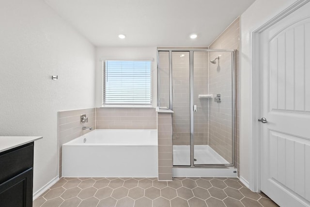 12126 Cantabria Rd, Austin, TX 78748 - bathroom with a bath, a stall shower, vanity, tile patterned flooring, and recessed lighting