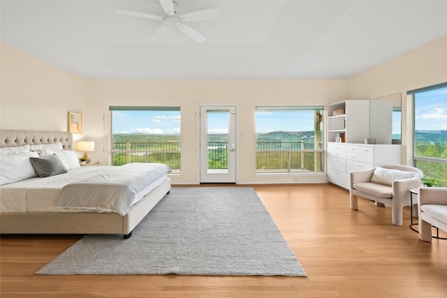 5926 N W Pl, Austin, TX 78731 - bedroom with access to exterior, wood finished floors, and ceiling fan