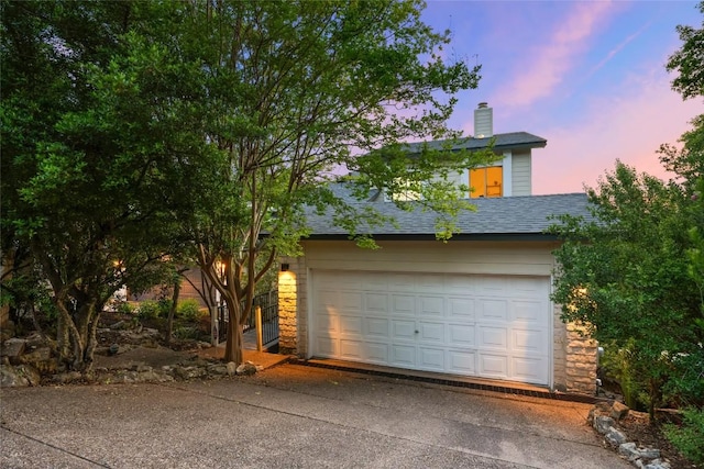 5926 N W Pl, Austin, TX 78731 - view of front of home with a chimney, a garage, driveway, stone siding, and a shingled roof