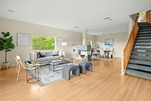 living area featuring stairs, recessed lighting, baseboards, wood finished floors, and visible vents