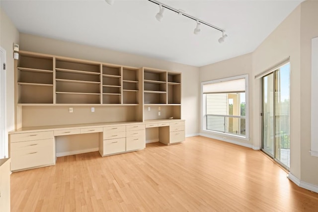 5926 N W Pl, Austin, TX 78731 - unfurnished office featuring track lighting, built in desk, light wood-style flooring, and baseboards