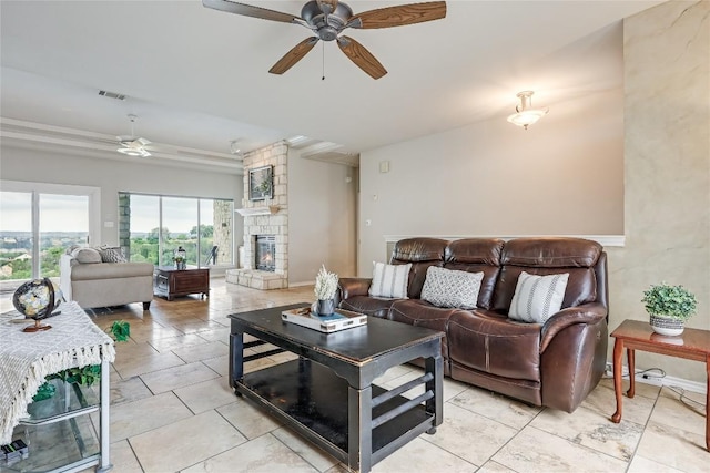 3606 Bunyan Cir, Lago Vista, TX 78645 - living room with a ceiling fan, light tile patterned flooring, and a stone fireplace