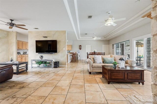 3606 Bunyan Cir, Lago Vista, TX 78645 - living room with ceiling fan, a raised ceiling, and light tile patterned floors