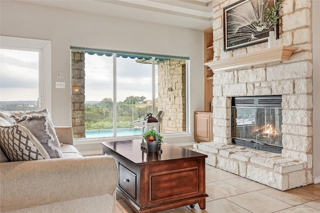3606 Bunyan Cir, Lago Vista, TX 78645 - living area featuring a fireplace, light tile patterned floors, built in shelves, and baseboards