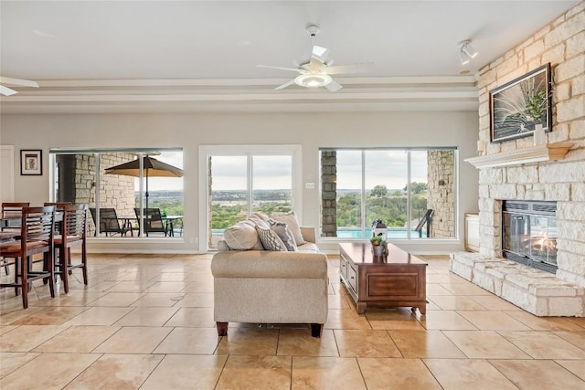 3606 Bunyan Cir, Lago Vista, TX 78645 - living area with a fireplace, a ceiling fan, healthy amount of natural light, and light tile patterned flooring