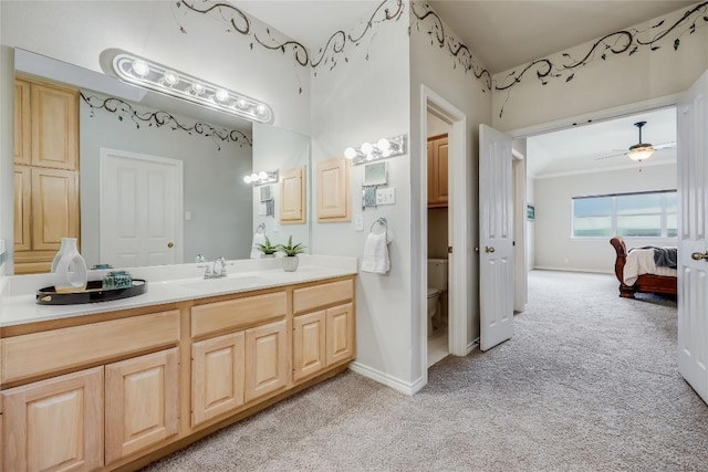 3606 Bunyan Cir, Lago Vista, TX 78645 - bathroom featuring carpet floors, vanity, toilet, baseboards, and a ceiling fan