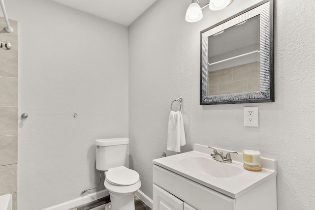 full bath with vanity, walk in shower, wood finished floors, and toilet