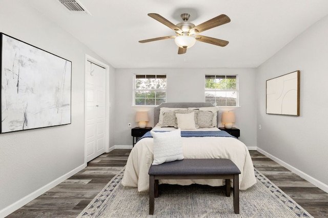 bedroom with baseboards, a ceiling fan, wood finished floors, and visible vents