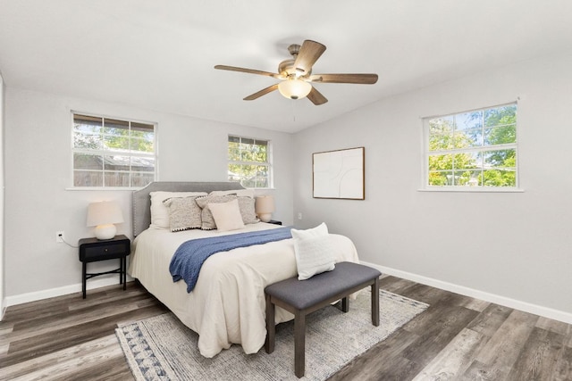 bedroom featuring baseboards, ceiling fan, vaulted ceiling, and wood finished floors