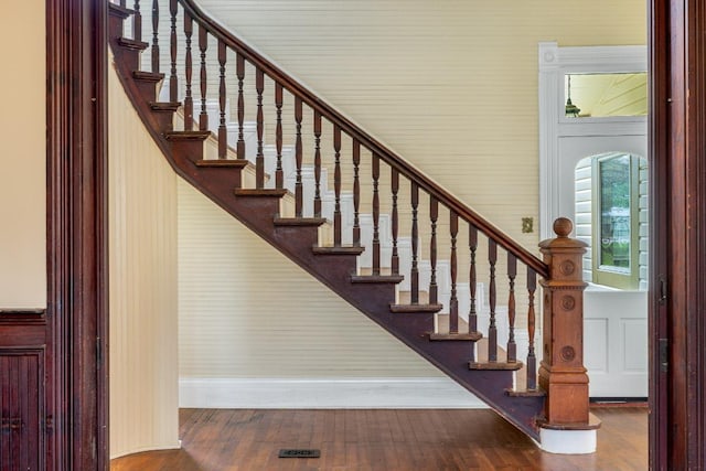 stairs featuring baseboards and wood finished floors