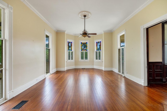 unfurnished room featuring wood-type flooring, ceiling fan, visible vents, and baseboards
