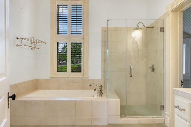 bathroom with a garden tub and a stall shower