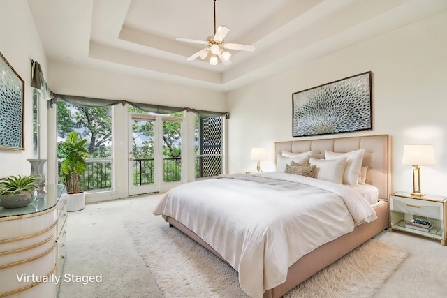 carpeted bedroom featuring a ceiling fan and access to exterior