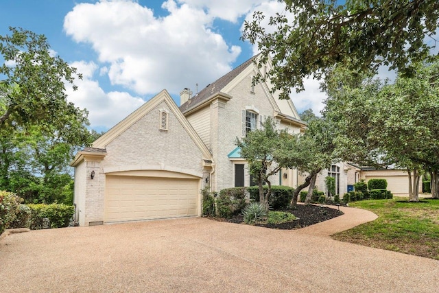 7100 Valburn Dr, Austin, TX 78731 - french country inspired facade featuring concrete driveway, brick siding, and a garage