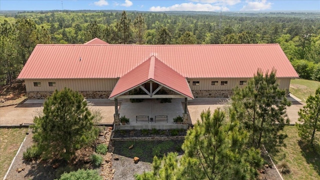 drone / aerial view featuring a wooded view