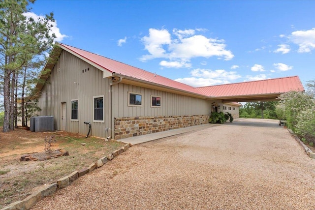 178 Pine Tree Loop, Bastrop, TX 78602 - view of home's exterior with a metal roof, board and batten siding, and driveway
